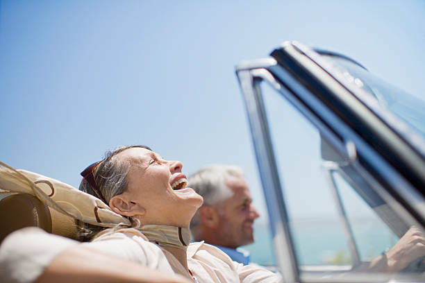 Mature couple driving in convertible  affluent lifestyles stock pictures, royalty-free photos & images