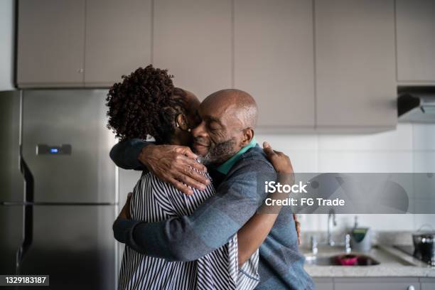 Mature couple embracing at home
