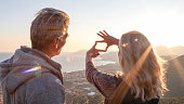 istock Mature couple relax at coastal viewpoint at sunrise 1328929808