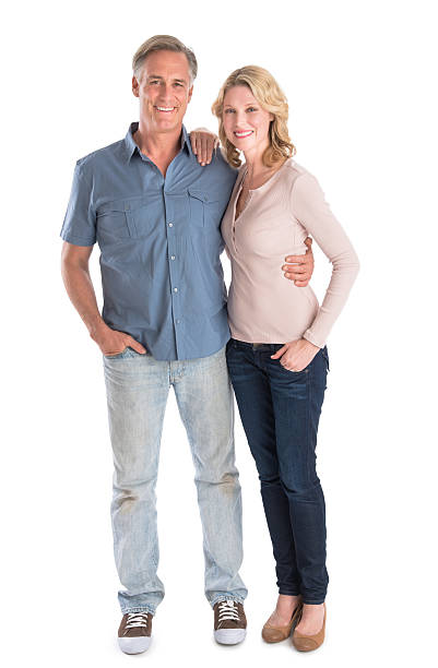 Mature Couple Standing With Hands In Pockets stock photo
