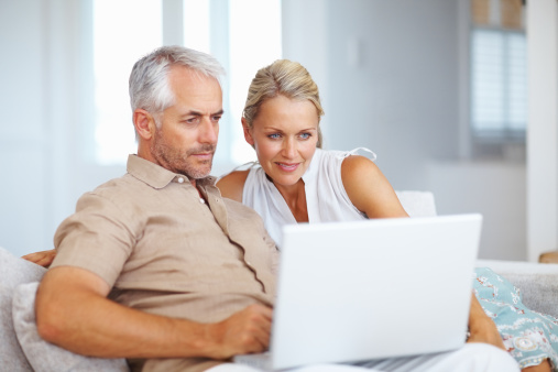 Mature Couple Using Laptop At Home Stock Photo - Download Image Now ...
