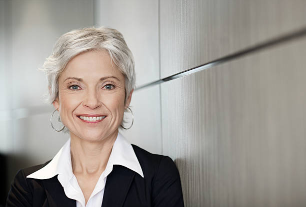 Mature executive business woman smiling stock photo