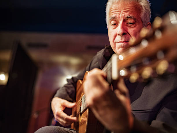 Mature male Guitarist on the stage stock photo
