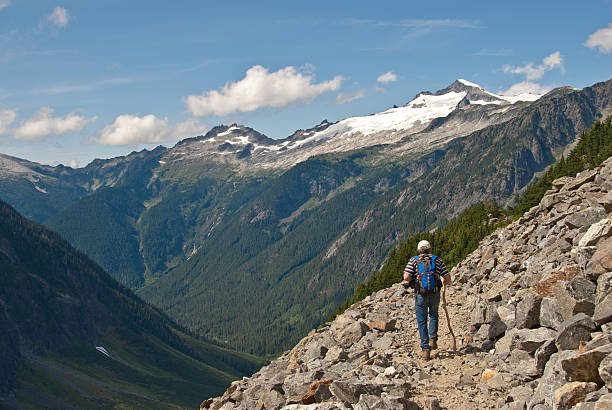 Mature Male Hiking in the North Cascades This mature male hiker was hiking the Cascade Pass Trail in North Cascades National Park, Washington State, USA. jeff goulden north cascades national park stock pictures, royalty-free photos & images
