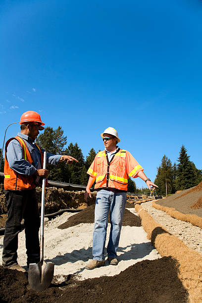 Mature male Project Manager overseeing Erosion control safety gear orange Project Manager overseeing Erosion control erosion control stock pictures, royalty-free photos & images