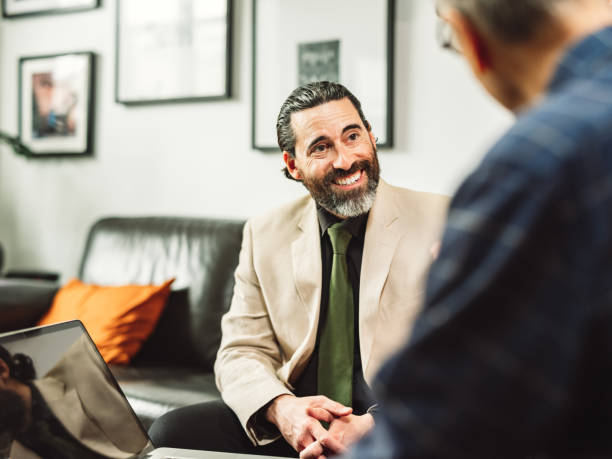 Mature male Real Estate Agent meeting with male senior client stock photo