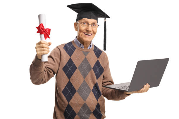 Mature man holding a graduation degree diploma and a laptop computer Mature man holding a graduation degree diploma and a laptop computer isolated on white background online degree stock pictures, royalty-free photos & images