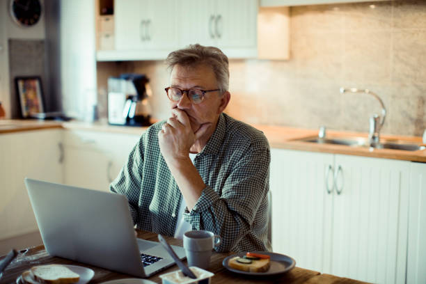 Mature man using a Laptop stock photo