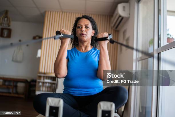 Mature woman exercising at a pilates studio