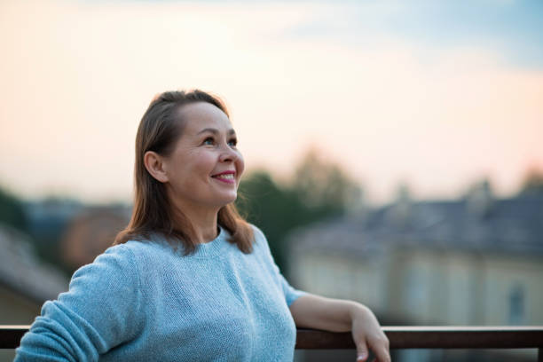 Mature woman looking optimistic on the future over evening sky Woman's portrait with copy space russian mature women stock pictures, royalty-free photos & images