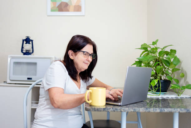 Mature woman using laptop stock photo