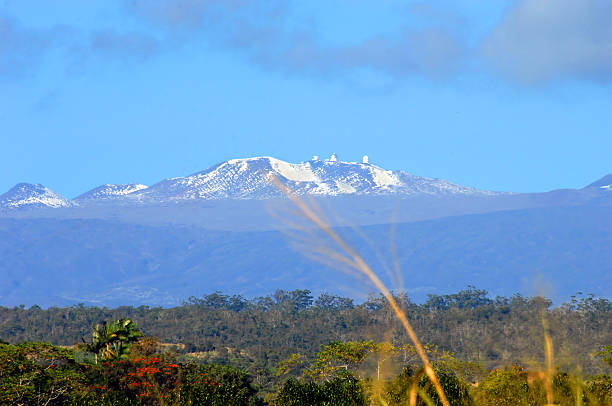 Mauna Kea and Snow capped Peaks Low elevation view of the observatory at the top of Mauna Kea.  Big Island is tropical but also has the snow capped peak of Mauna Kea. mauna kea stock pictures, royalty-free photos & images