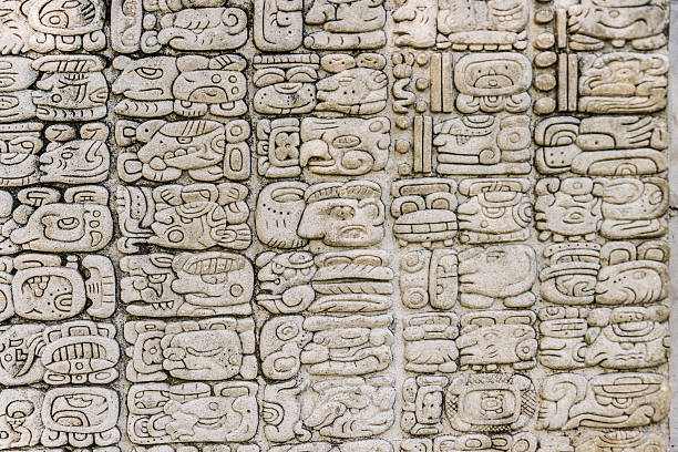 Mayan hieroglyphics -XXXL Mayan hieroglyphics carved in a stone facade (replica). mayan stock pictures, royalty-free photos & images