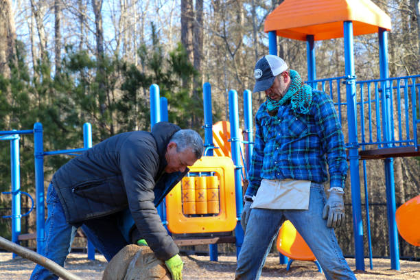 Mayor Dodd Ferrelle volunteers planting trees for 2019 MLK Day of Service in Winterville, Georgia. Winterville, Georgia - January 21, 2019: Mayor Dodd Ferrelle (photo right) participated in the MLK Day of Service planting trees with other volunteers at the Winterville Elementary School. martin luther king jr day stock pictures, royalty-free photos & images