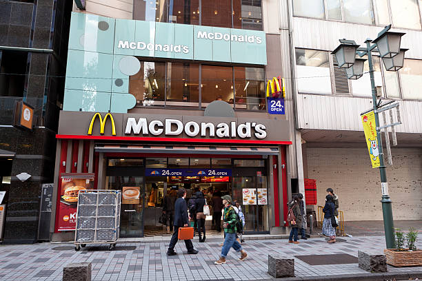 McDonald's restaurant in Japan Tokyo, Japan - November 24, 2011: Pedestrians walk past a McDonald\'s restaurant in Shinjuku District, Tokyo, Japan.  Some customers buy food at a McDonald\'s restaurant. McDonald\'s has over 3000 restaurants in Japan. mcdonalds japan stock pictures, royalty-free photos & images