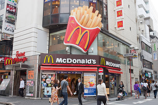 McDonald's restaurant in Japan "Tokyo, Japan - June 10, 2008 : Pedestrians walk past a McDonald's restaurant in Shibuya Center Street, Tokyo, Japan. Some customers inside the McDonald's restaurant. McDonald's has over 3000 restaurants in Japan." mcdonalds japan stock pictures, royalty-free photos & images