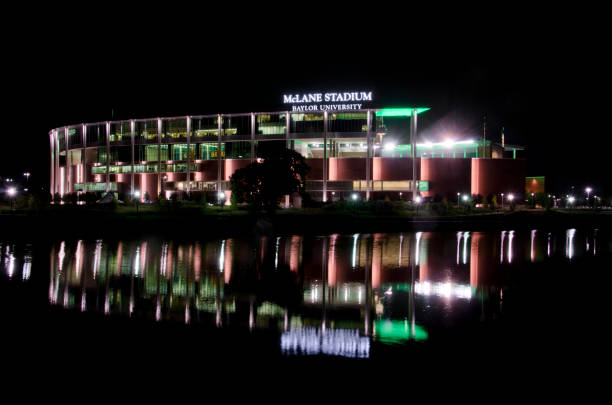 McLane Stadium at Baylor University Waco, United States - September 26, 2015: McLane Stadium is the brand new football venue on the campus of Baylor University.  It stands on the banks of the Brazos River, providing the latest in sports and technology for unversity students and supporters, as well as an area along the river to provide "sail gating," where sailboats can tie off and celebrate the pregame atmosphere. baylor football stock pictures, royalty-free photos & images