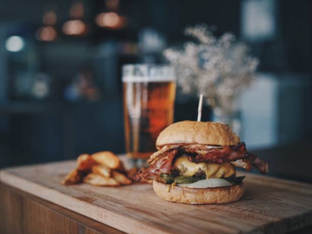 Meat burger with beer in cafe stock photo