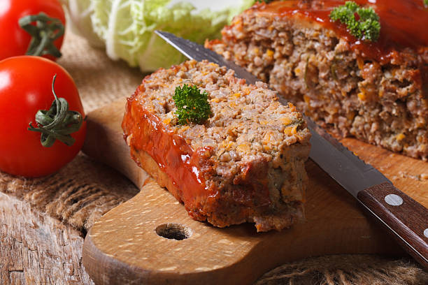 meat loaf close-up on a cutting board. horizontal - meatloaf stockfoto's en -beelden