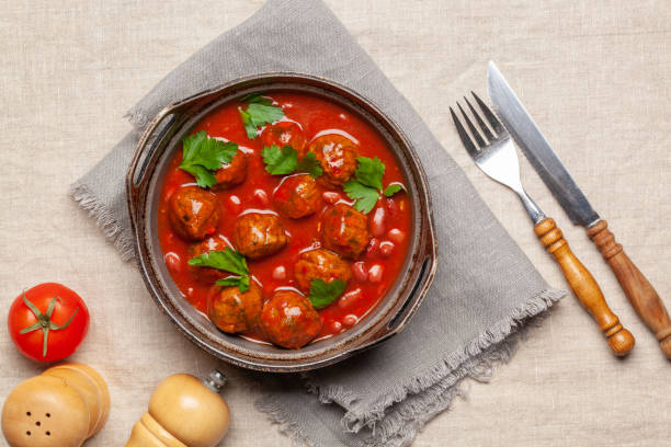 Meat or vegetable meatballs in tomato sauce with beans. Top view. stock photo