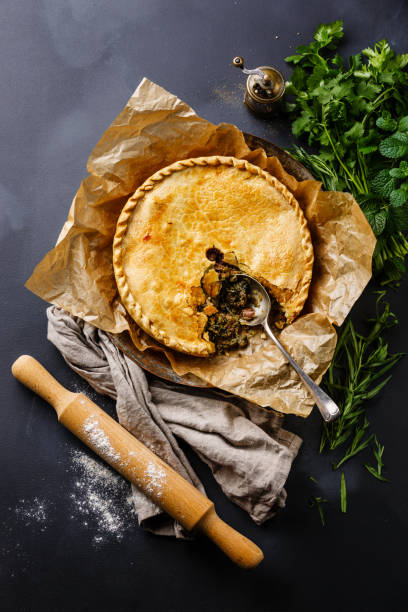 Meat Pie with herbs Meat Pie with herbs on blackboard slate background meat pie stock pictures, royalty-free photos & images