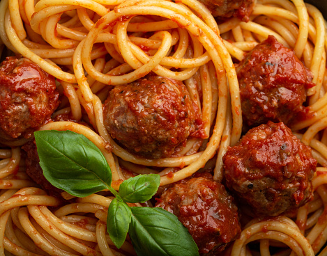 Close-up of delicious meatballs pasta with tomato sauce, from above. Tasty homemade meatballs spaghetti concept, food pattern background