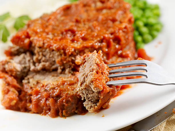 meatloaf baked in tomato sauce - meatloaf stockfoto's en -beelden