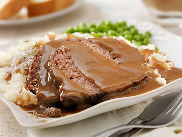 Meatloaf Dinner "Meatloaf with Gravy, Mashed Potatoes and Green Peas -Photographed on Hasselblad H3D2-39mb Camera" meat loaf stock pictures, royalty-free photos & images