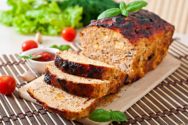 meatloaf sliced on wooden board with ketchup and tomatoes - meat loaf stok fotoğraflar ve resimler