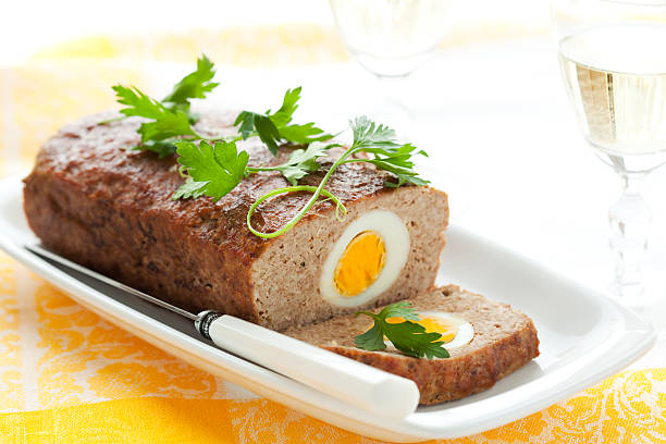 meatloaf with boiled eggs - meatloaf stockfoto's en -beelden