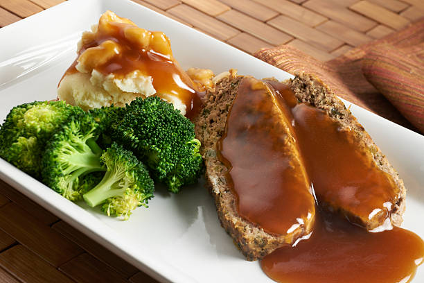 Meatloaf with mashed potatoes "Comfort food, home style. Two sliced of meatloaf with mashed potatoes, gravy and steamed broccoli." meat loaf stock pictures, royalty-free photos & images