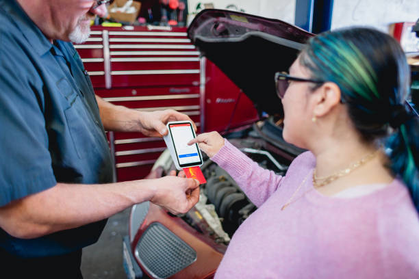 Mechanic and Customer In Auto Repair Shop stock photo