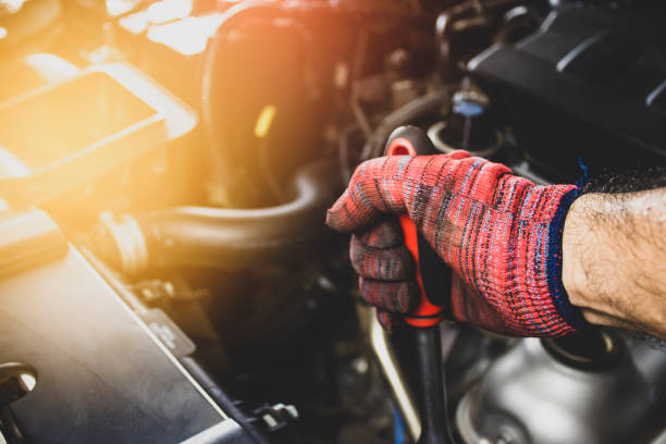 Mechanic wears red cloth gloves stock photo