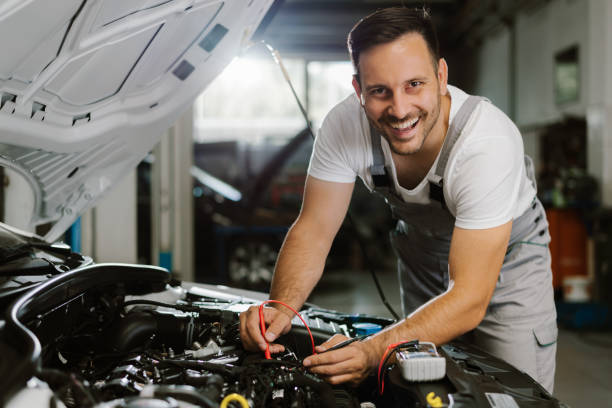 Mechanic working with car diagnostic tool in a workshop stock photo