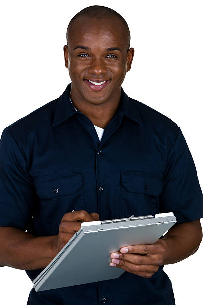 Mechanic writing up estimate Vertical composition of a mechanic writing up an estimate  african american plumber stock pictures, royalty-free photos & images