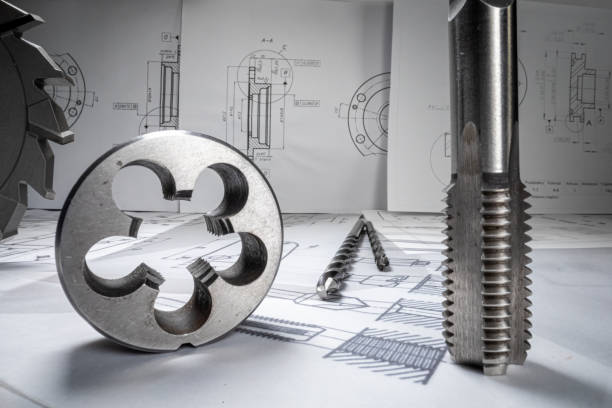 Mechanical diagrams, bearings and drills. Mechanical parts on designer desk. stock photo