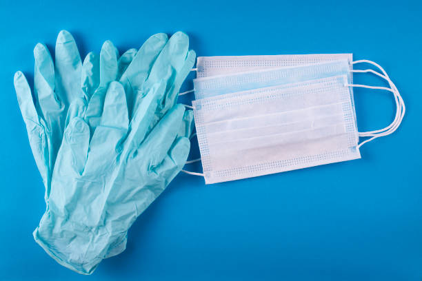Medical bandages and gloves on a blue background. stock photo