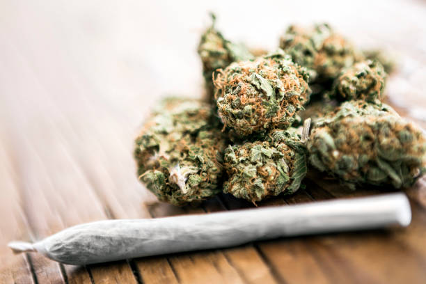 Medical cannabis joint on cannabis buds Medical cannabis joint on cannabis buds on wooden table marijuana joint stock pictures, royalty-free photos & images