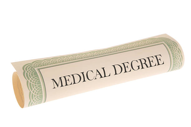 Medical Degree - Scroll Document on White Background Medical Degree on rolled up scroll document on white background.  Stock image of a rolled up certificate or page isolated on white.  Edge design on paper is my own design. medical degrees stock pictures, royalty-free photos & images