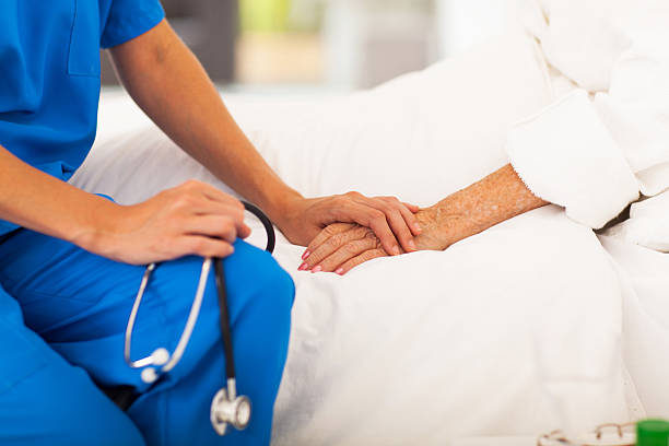 medical doctor comforting senior patient stock photo