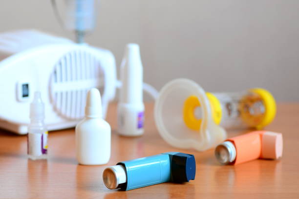 Medical equipment and drugs for bronchial asthma treatment. Aerosol inhalation nebulizer, medical asthma spray inhaler, spacer, nebula, anti-inflammatory drugs to manage asthma. Bronchi asthma cure, emergency allergy asthma concept stock photo