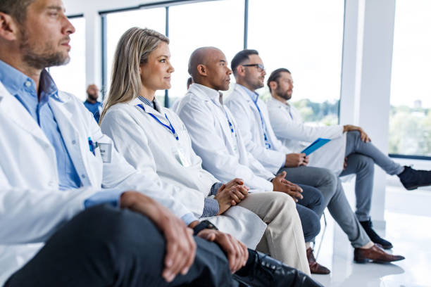 Medical experts attending an education event in board room. stock photo