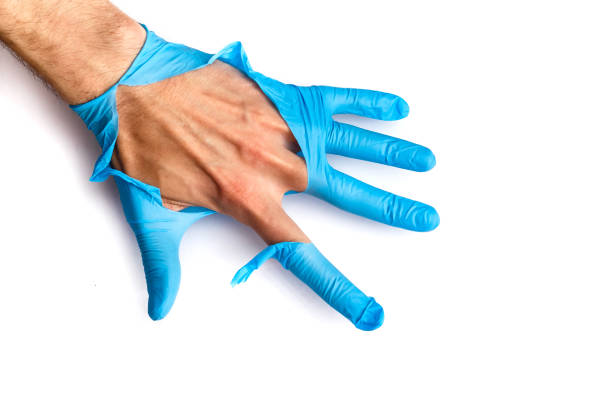 Medical glove in hand on white background stock photo