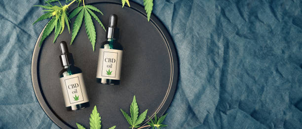 Medical marijuana and cannabis products CBD oil, hemp leaves on dark background Medical marijuana and cannabis products CBD oil, hemp leaves on a dark background. Flat lay, copy space Mockup cbd oil stock pictures, royalty-free photos & images