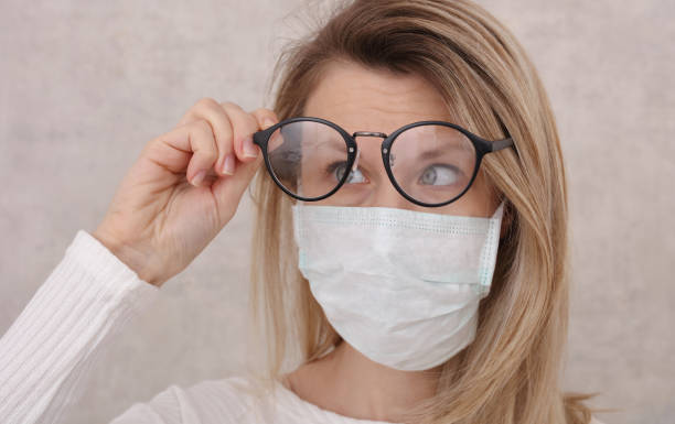 medical mask and glasses fogging. avoid face touching, coronavirus prevention, protection. - eyeglasses imagens e fotografias de stock