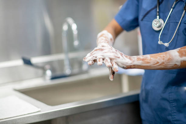 Nurse helping a senior woman to wash. - Royalty Free Image 