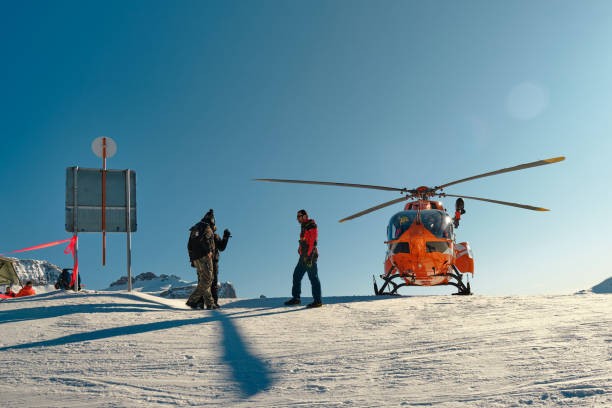 Medical rescue helicopter waiting to transport a skier, on the Dolomiti Superski domain in Italy. stock photo