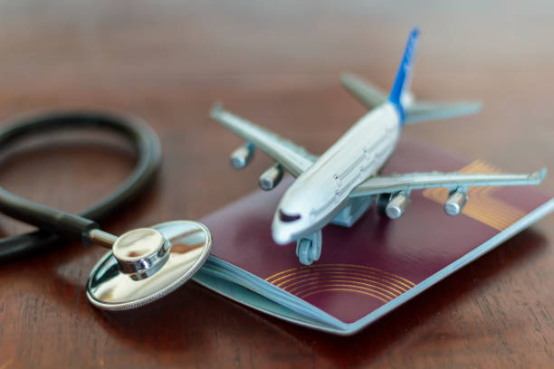 Medical Stethoscope , passport and an airplane. Global Healthcare and travel insurance concept stock photo