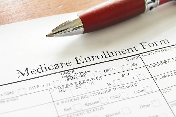 Medicare Enrollment Form and a red pen stock photo