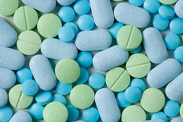 Medicine Pills Blue & Green Medicine Tables. bunch photos stock pictures, royalty-free photos & images